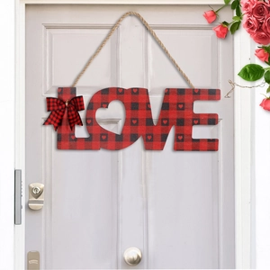 Close-up of LOVE wooden door sign with buffalo plaid pattern and red heart details