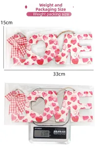 Detailed view of pink LOVE wooden sign with fabric bow and hanging jute rope