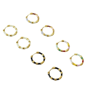 Minimalist gold plated huggie earrings with colorful enamel sections in various vibrant colors