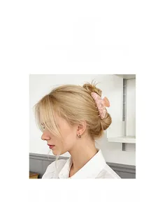 Pink marble pattern hair claw clip with pearl accents shown on model's hair