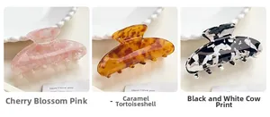 Acetate hair claws in cherry blossom pink, caramel tortoiseshell, and cow print patterns