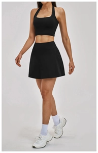 Close-up of black seamless yoga set with halter tank top and high-waist sports skirt
