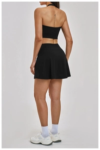 Rear view of black backless sports top and pleated tennis skirt set for women