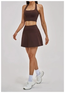 Detail shot of dark brown halter yoga top and matching tennis skirt on a model