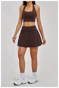 Front view of brown halter sports bra and matching athletic skirt set for yoga training