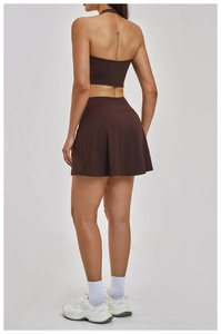 Rear view showing racerback cropped top and matching tennis skirt in coffee brown stretch fabric