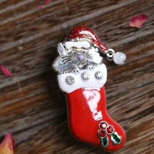 Christmas cat brooch in red stocking with enamel finish and sparkling rhinestones