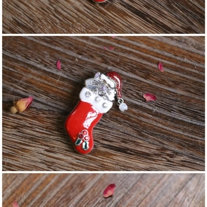 Christmas brooch featuring a cute cat in a red stocking with crystals and holly detail