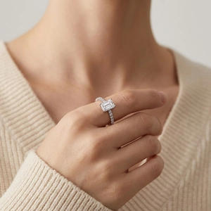 Sparkling S925 sterling silver ring with emerald-cut moissanite worn by a model