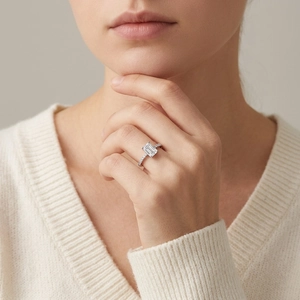 Elegant S925 silver ring featuring emerald cut moissanite and pave set side stones