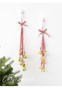 Detail of golden metal bells with red plaid ribbons for Christmas tree decoration