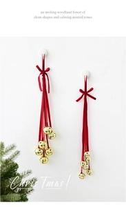 Detail of red velvet ribbons and gold star-cutout metal bells for Christmas decor