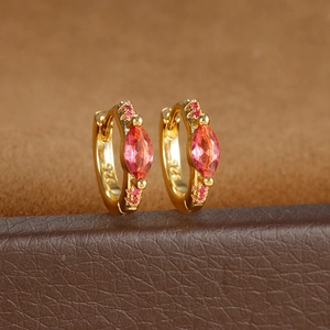 Detailed close-up of S925 silver stamp on gold hoop earrings with pink gemstones