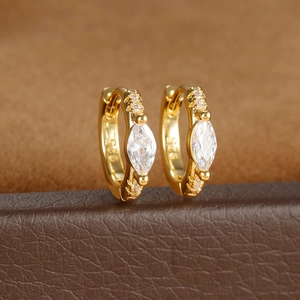 Detail of 925 silver stamp on gold plated zircon rhombus earrings with marquise cut