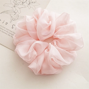 Close-up of light pink oversized chiffon scrunchie showing delicate organza texture