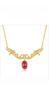 Detailed view of S925 silver gold-plated garnet pendant with vintage filigree design