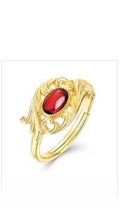 Detail of vintage gold plated garnet ring showing floral filigree and adjustable open band