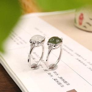 Macro detail of S925 silver Hetian jade rings with hollow flower setting and open band