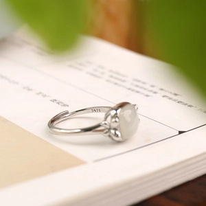 Detail of S925 silver Hetian jade ring with engraved adjustable band and white gemstone