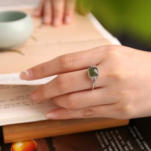 Close-up of S925 silver Hetian jade ring with butterfly side details on a hand