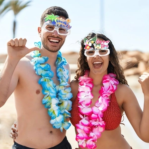 Hawaii party glasses and colorful flower leis set for summer beach pool celebrations
