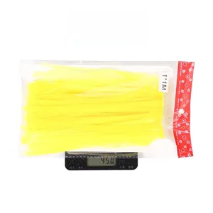 Neon macaron yellow tinsel fringe curtain 1x1m being weighed at 45 grams on scale