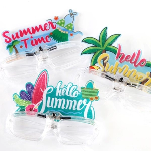 Close-up of clear LED party glasses with tropical coconut tree and summer beach motifs