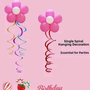 Detail of pink flower balloon with colorful birthday party hanging swirls on pink background