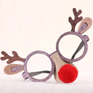 Detail of Christmas reindeer glasses frame with glitter antlers and a soft red plush nose