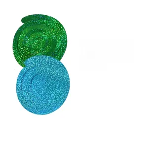 Close-up of sparkling green and blue spiral streamers with glitter for party decorations