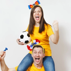Close-up of vibrant soccer bow headbands with national flag colors and mini ball detail