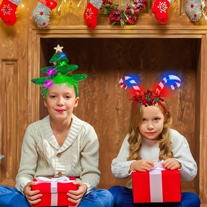Close-up of children's LED Christmas headbands with shiny tree and candy cane designs