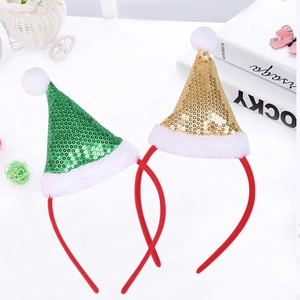 Close-up of sparkling sequin Christmas hat headbands in festive green and gold colors