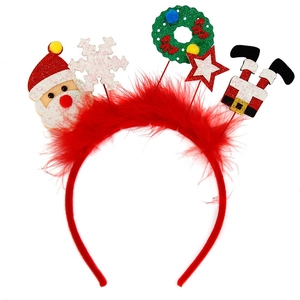 Detail of Christmas headband with Santa, snowflake, and star on red feather trim