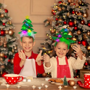Detail of kids wearing glowing green LED Christmas tree headbands with yellow stars