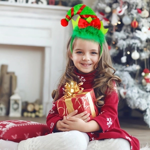 Detail of Christmas elf hat headband with bells and feathers on a girl in a red snowflake dress