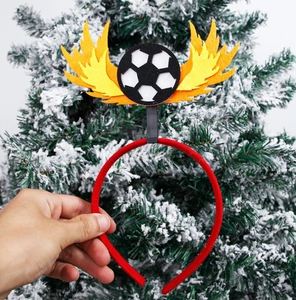 Detail showing the football and felt flame decoration on a red soccer party headband