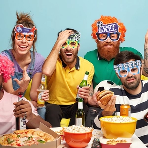 Close-up of vibrant soccer party felt glasses worn by friends at a World Cup event