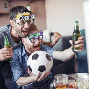 Detail of fans wearing football and soccer themed party paper glasses for world cup events