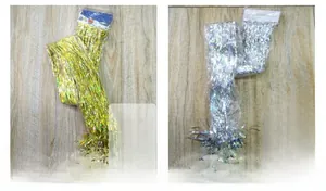 Detail of metallic gold and silver tinsel fringe curtains in retail packaging