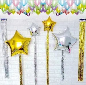 Detail of gold and silver star balloons with shiny metallic fringe for party backdrop