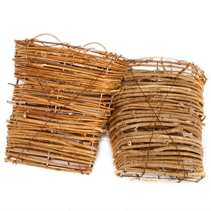 Detail of handmade wicker wall baskets with natural vines and sturdy metal frames