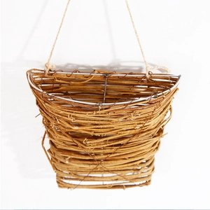 Detail of a handmade woven wall basket with metal hooks and natural wicker texture