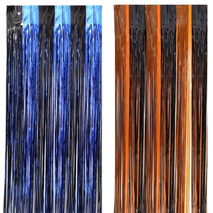Detail view of bicolor tinsel foil curtains in blue black and orange black for party decor