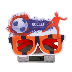 Close-up of lightweight soccer party glasses on a scale weighing 17.4g with football motifs