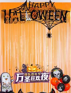 Halloween set with orange foil curtains, black spiderweb banner, and festive balloons
