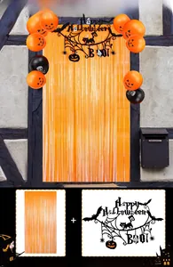 Halloween party set with orange fringe curtains, pumpkin balloons and black bat banners