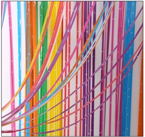 Macro detail of macaron rainbow star foil fringe curtain for festive party backdrop décor