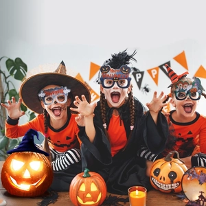 Three children wearing pumpkin and ghost Halloween party glasses in a festive setting