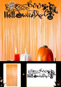 Detail of Halloween party set with orange tinsel curtain and black festive banner